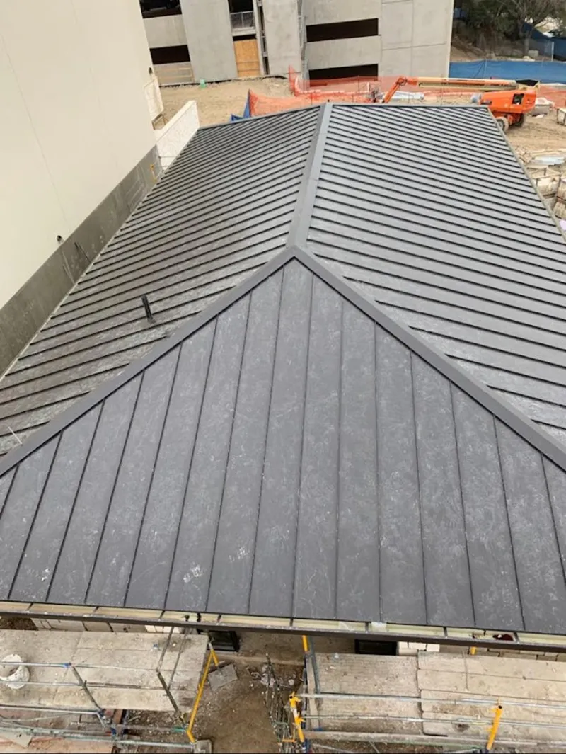 Commercial metal roof construction with crane equipment in Clarkdale