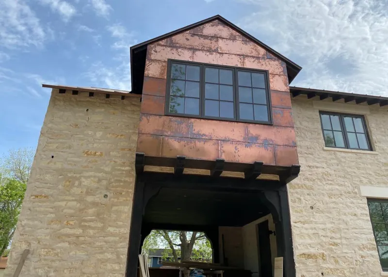 Copper metal panel facade on a stone building for Roof Repair in Clarkdale